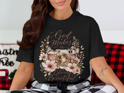Black t-shirt with a vintage camera surrounded by flowers and text reading "God Makes the Blurry Beautiful."