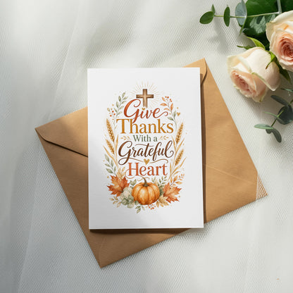 Card with text "Give Thanks With a Grateful Heart", a cross, pumpkin, and fall leaves.
