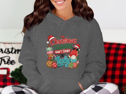 Christmas calories don't count in July graphic on a dark gray hoodie.