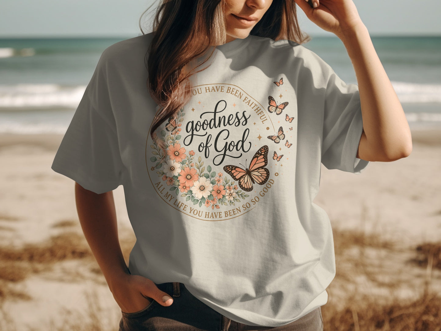 T-shirt with "Goodness of God" floral and butterfly design.