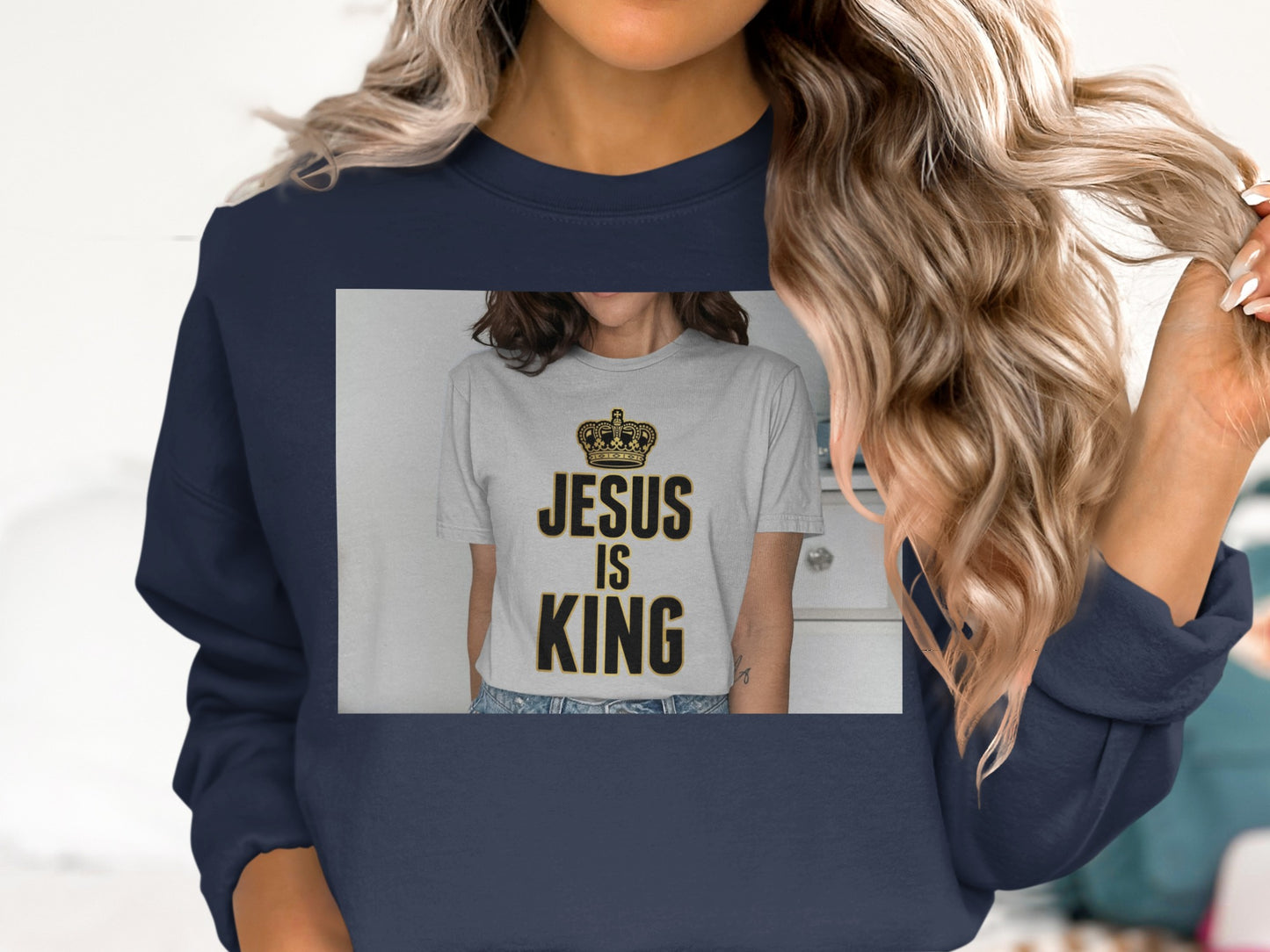 Navy sweatshirt with "Jesus is King" text on a grey t-shirt.