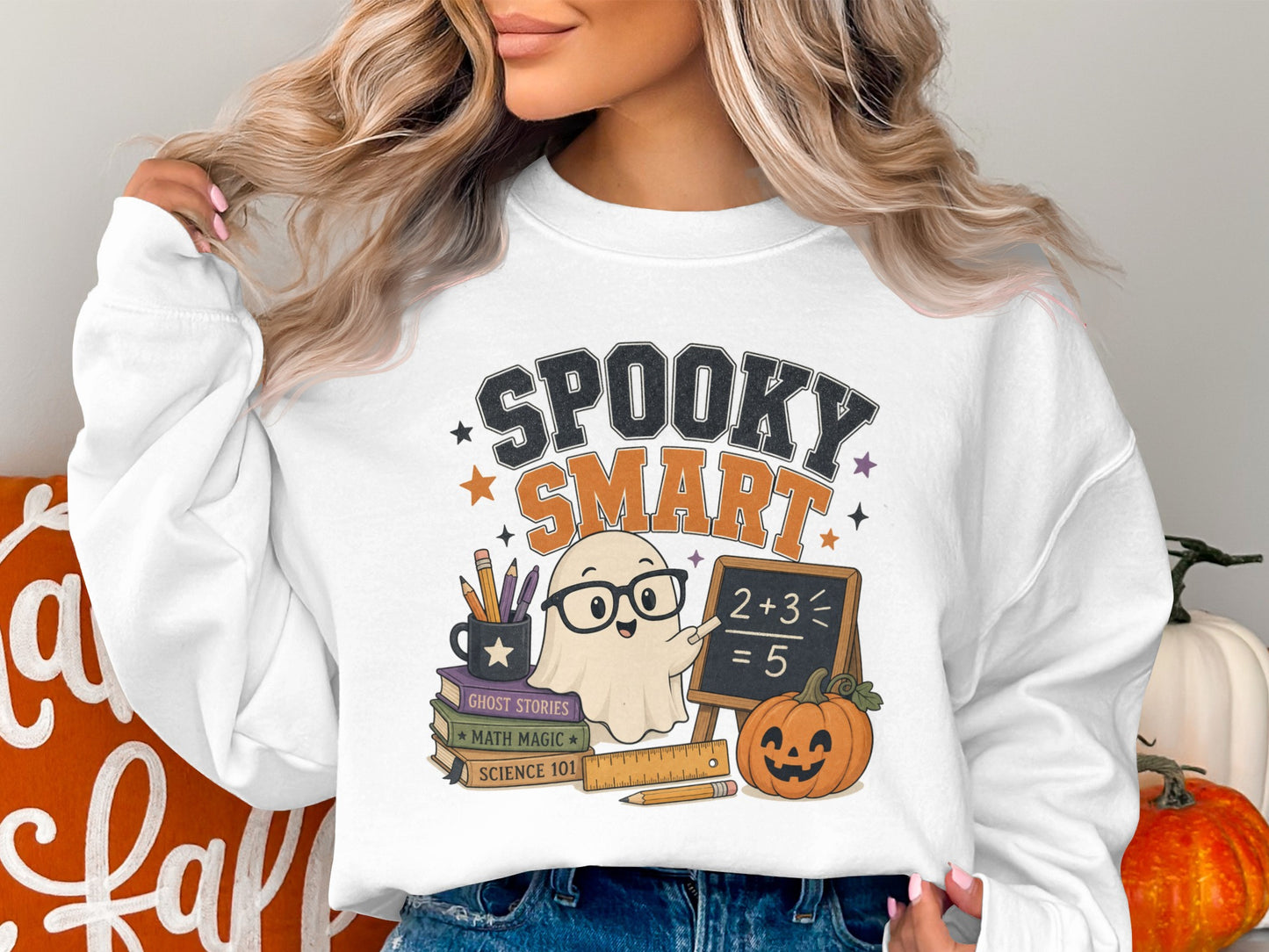 White sweatshirt with "Spooky Smart" text, ghost, chalkboard, books, and pumpkin graphic.