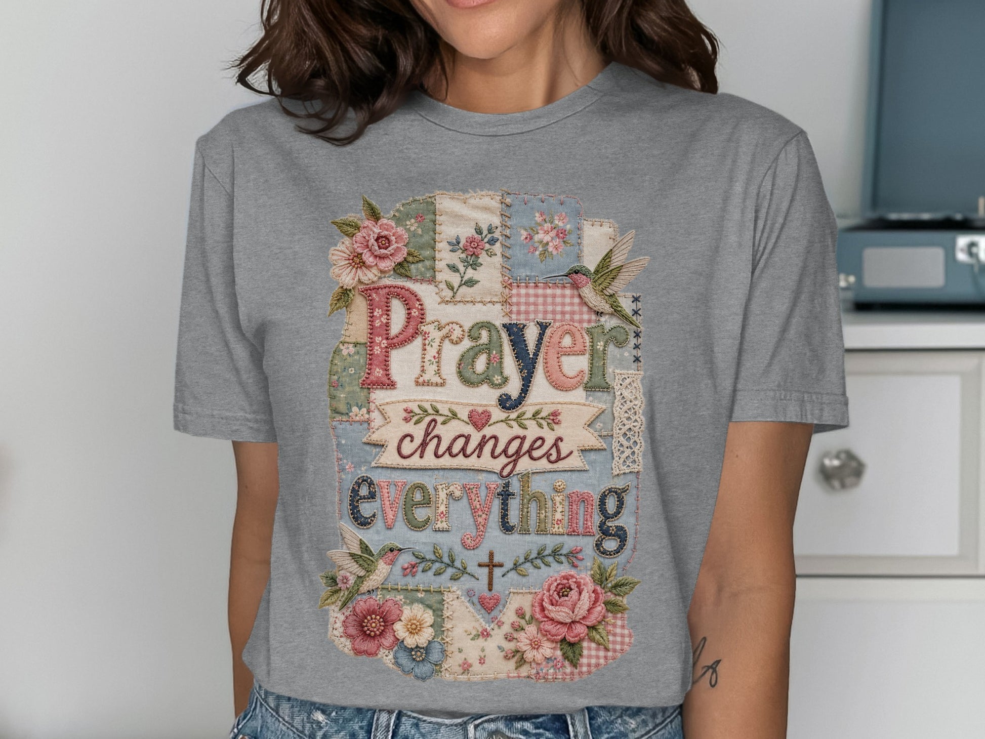 Gray t-shirt with "Prayer changes everything" in a patchwork design.
