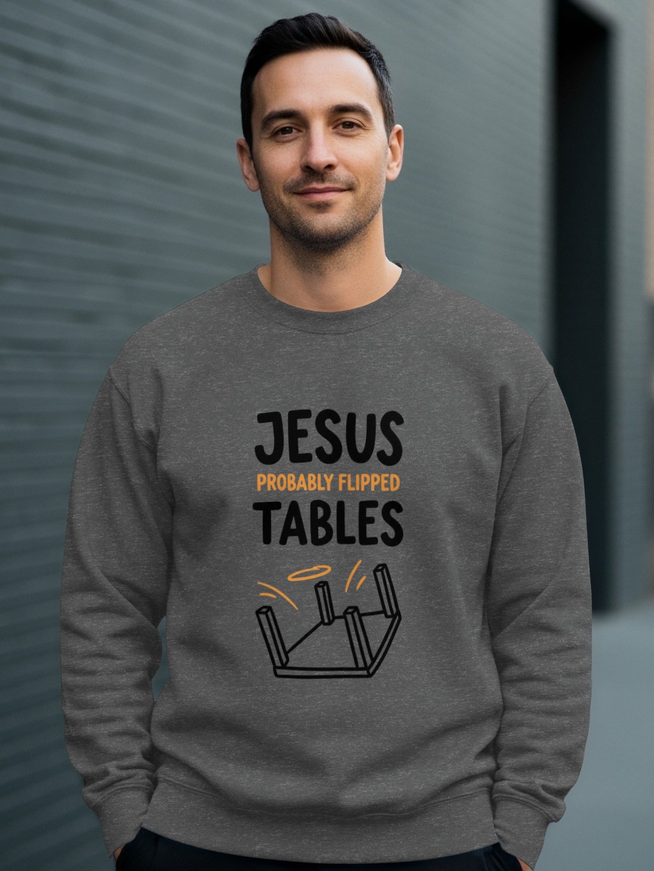 Man wearing gray sweatshirt with "JESUS PROBABLY FLIPPED TABLES" text.