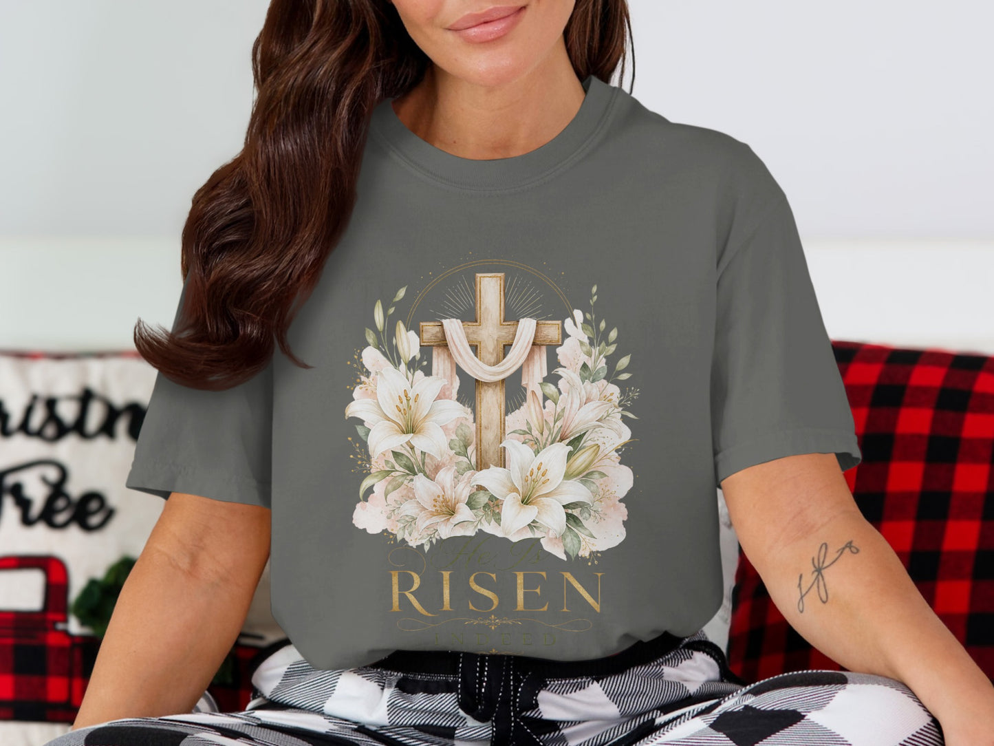 A gray t-shirt with a wooden cross, lilies, and the text "He is RISEN Indeed".