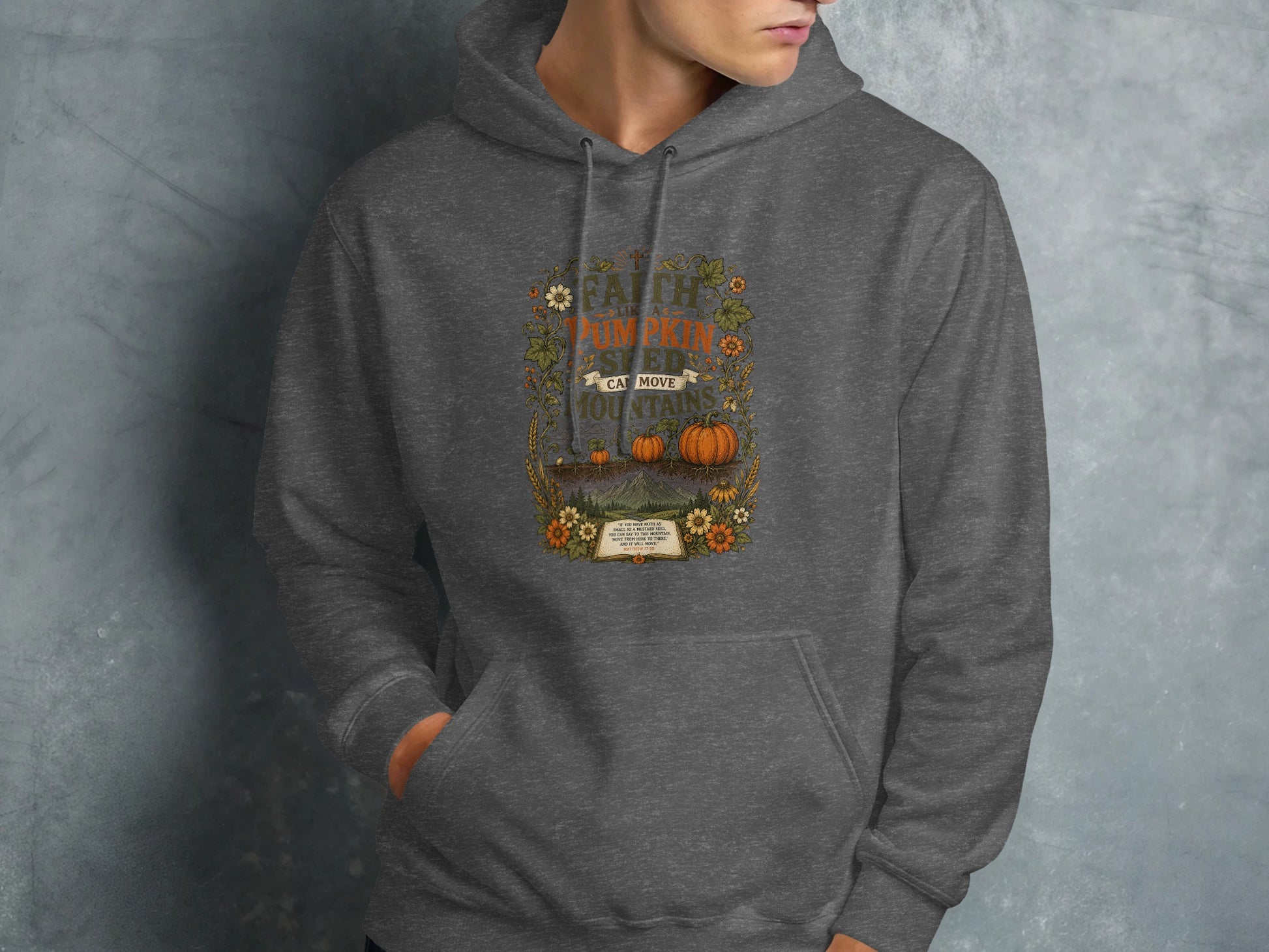 Gray hoodie with a floral and pumpkin graphic that reads "FAITH CAN MOVE MOUNTAINS".