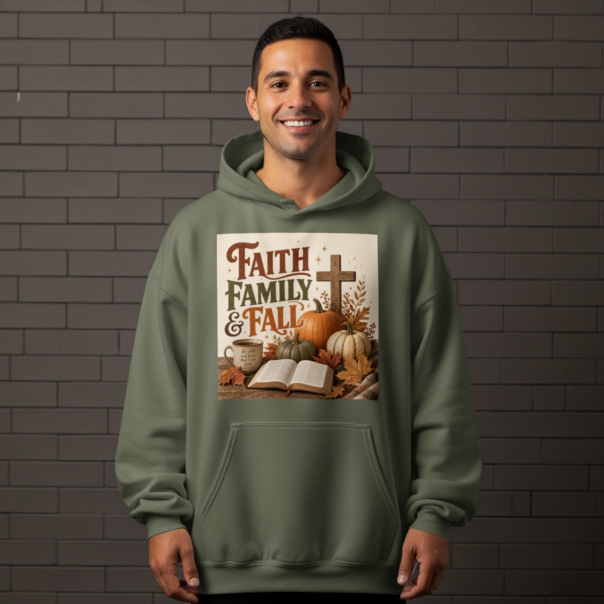 Olive green hoodie with a graphic depicting pumpkins, a cross, and text "Faith Family & Fall".