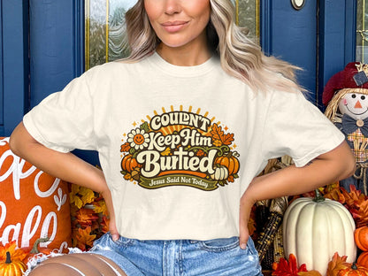 Cream t-shirt with "Couldn't Keep Him Buried" and "Jesus Said Not Today" text.