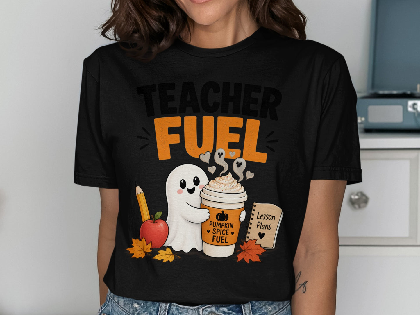 Black t-shirt with "TEACHER FUEL" and a ghost holding a pumpkin spice coffee.