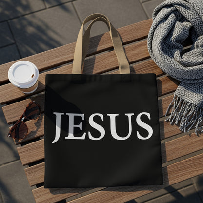Black tote bag with "JESUS" in white capital letters.