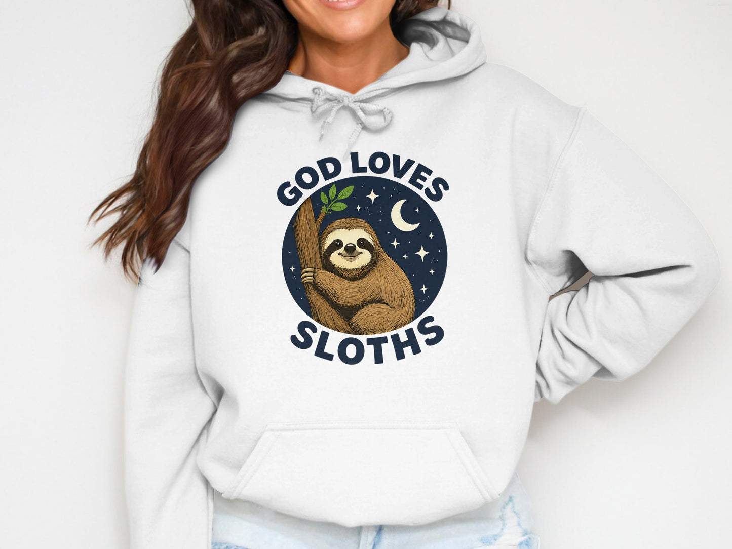 White hoodie with a graphic of a sloth holding a branch, saying "God Loves Sloths".
