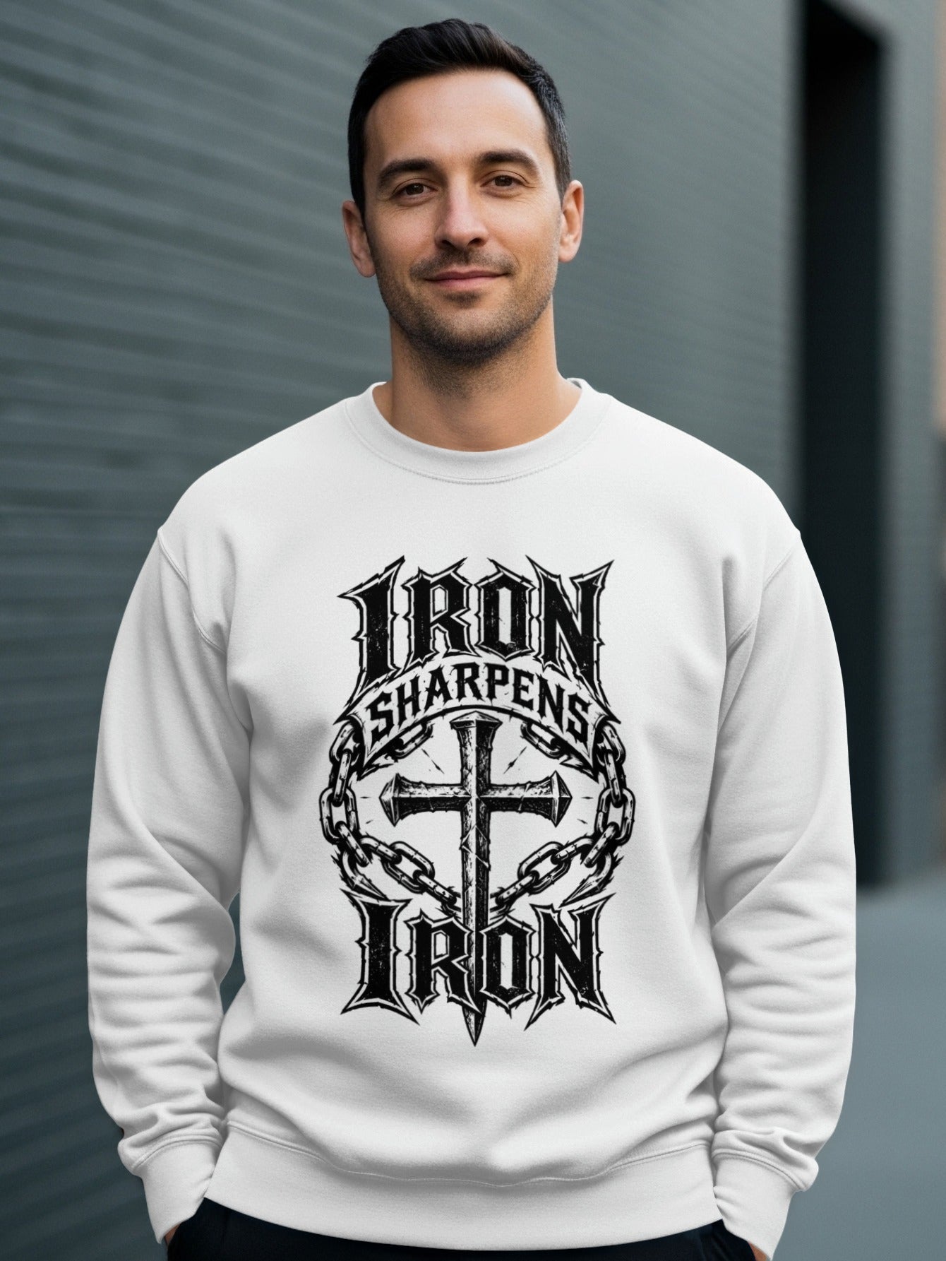 White sweatshirt with "Iron Sharpens Iron" and cross design.