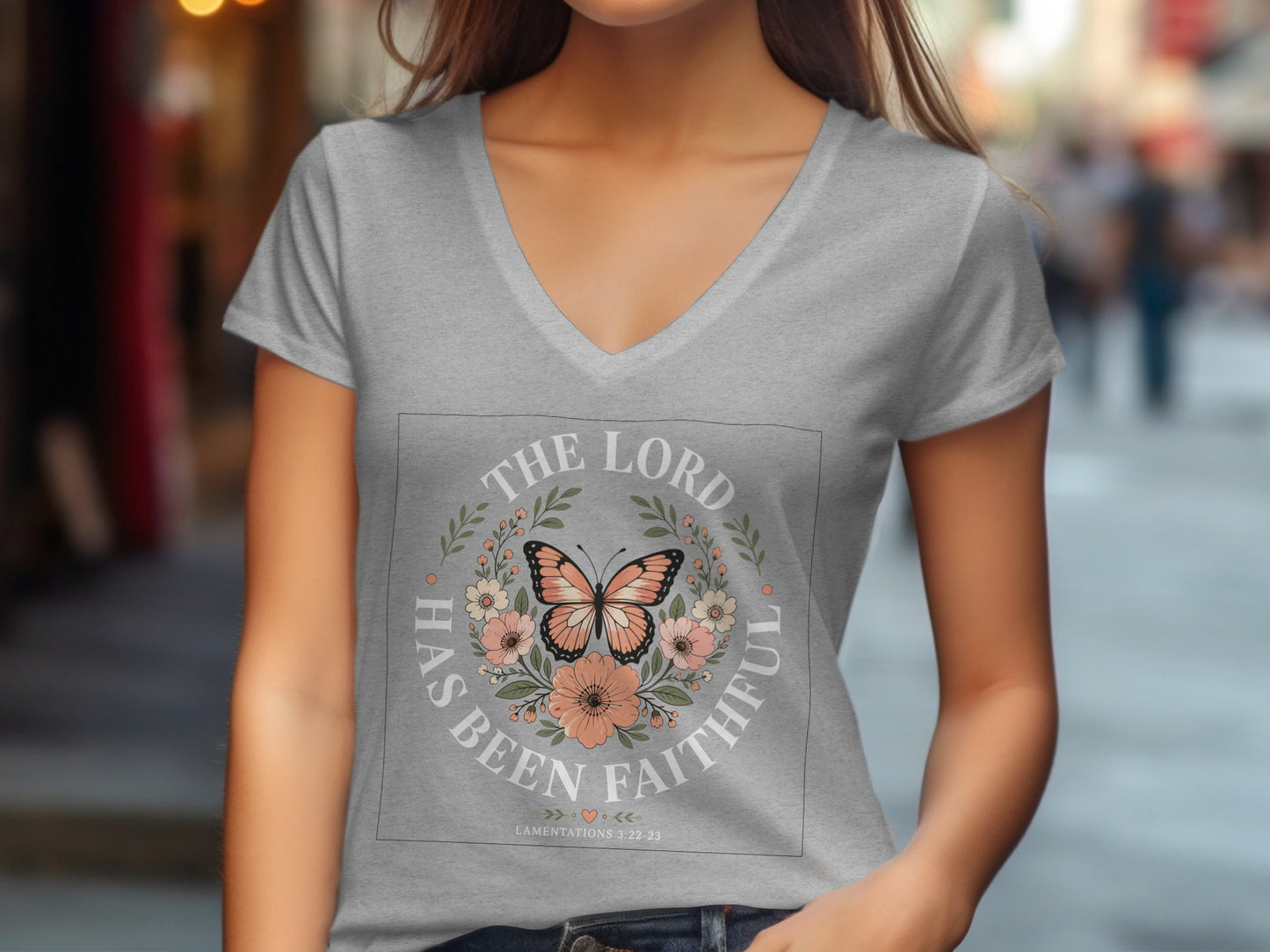Grey v-neck t-shirt with floral and butterfly design and text "The Lord Has Been Faithful".