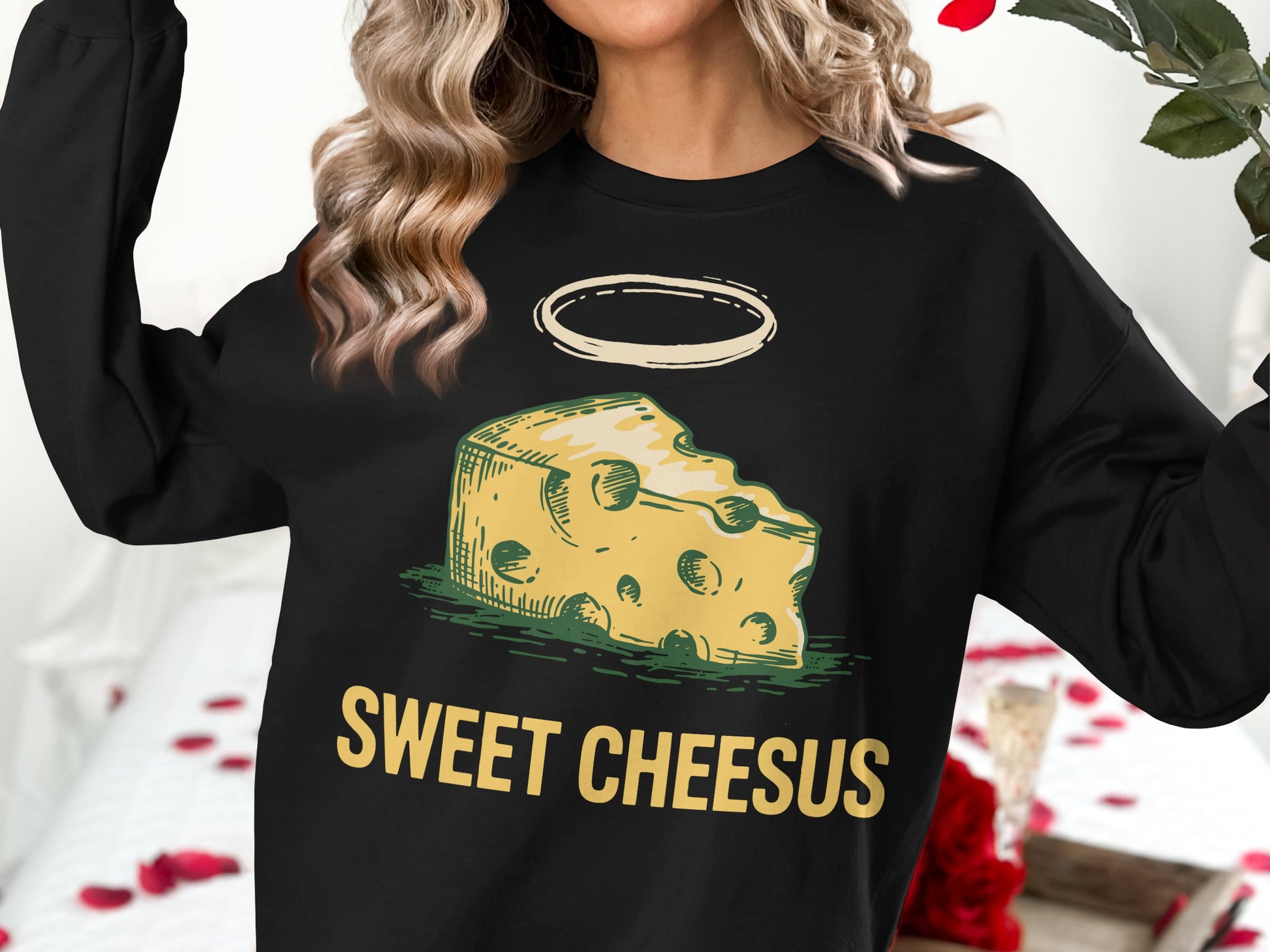 Black sweatshirt with a cartoon cheese slice with halo and "SWEET CHEESUS" text.