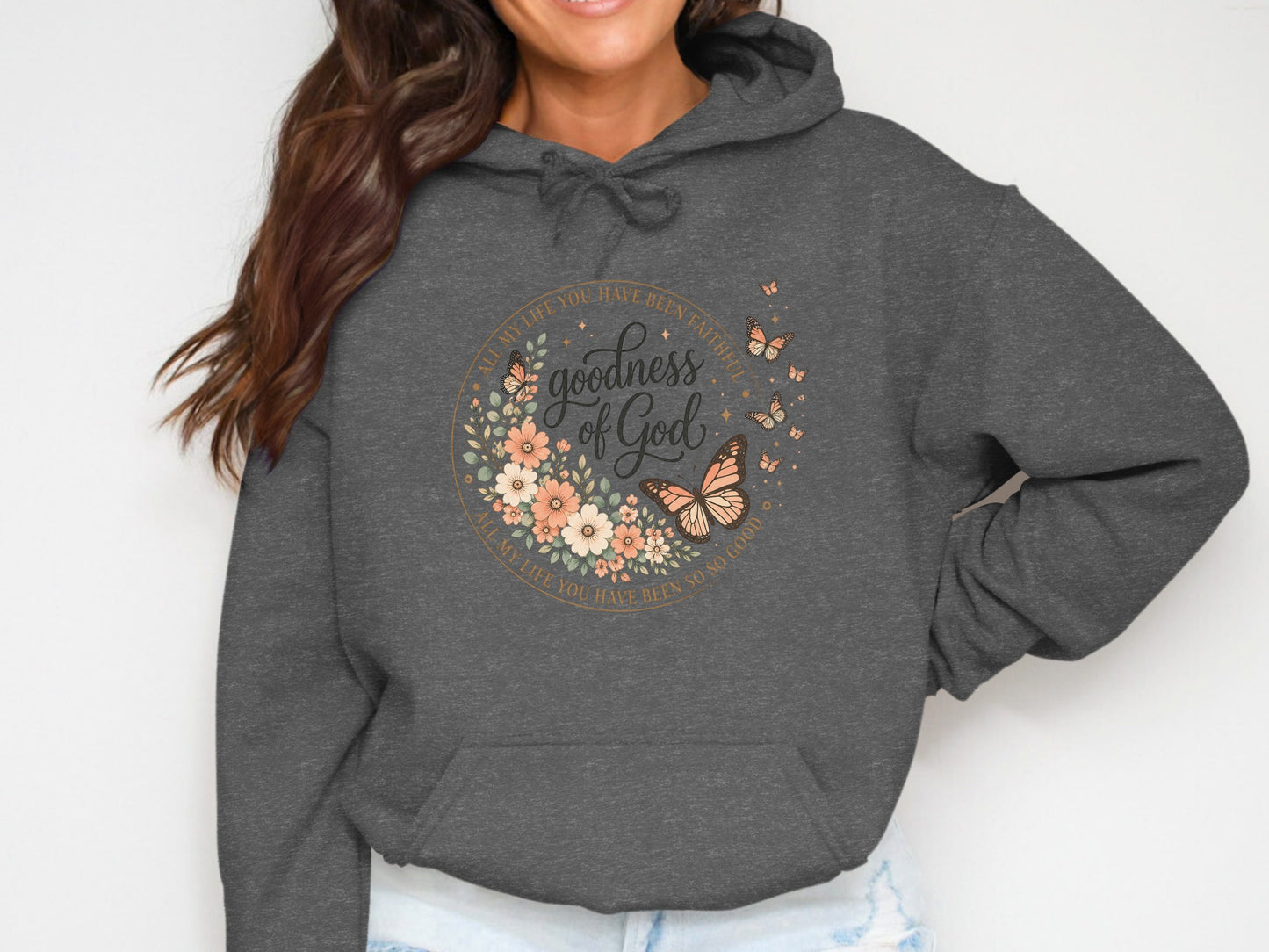 Dark grey hoodie with floral circle design featuring "goodness of God".