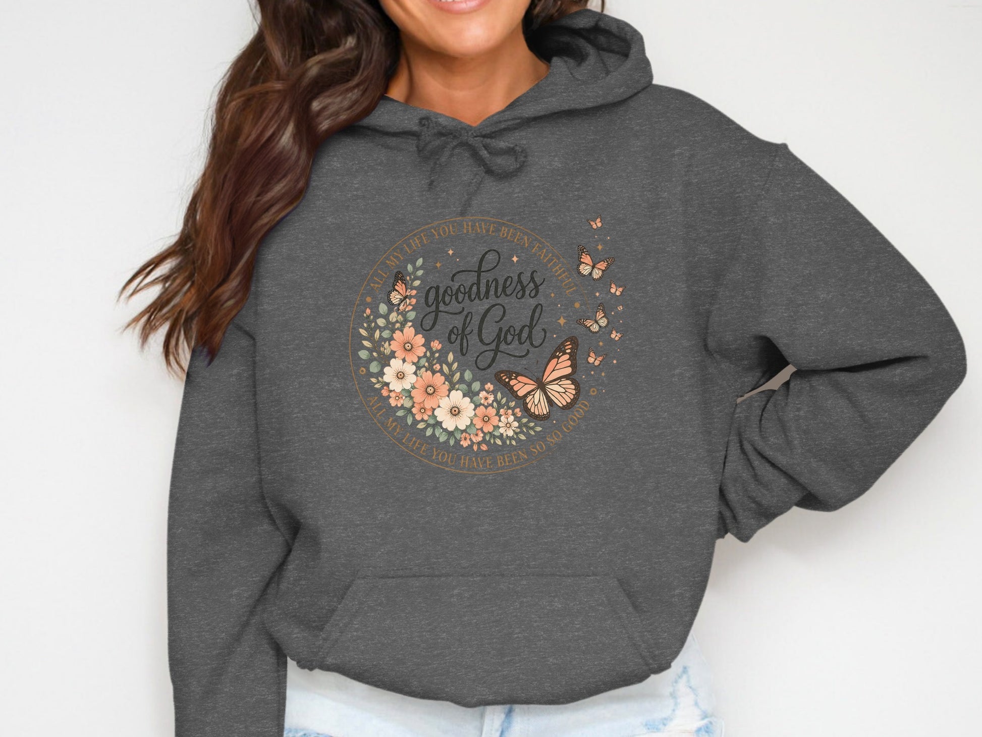 Dark grey hoodie with floral circle design featuring "goodness of God".