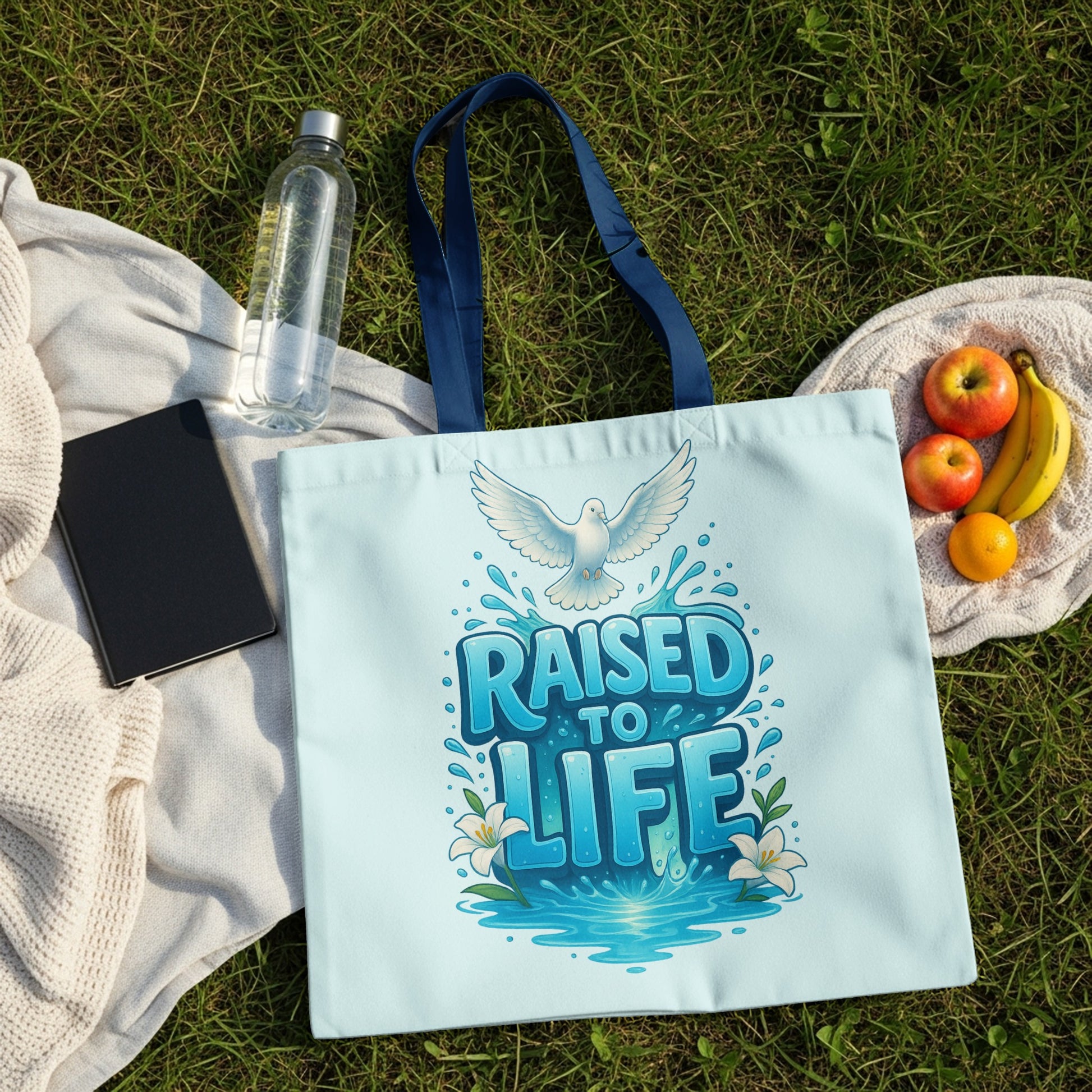 Light blue tote bag with "RAISED TO LIFE" text and dove graphic.