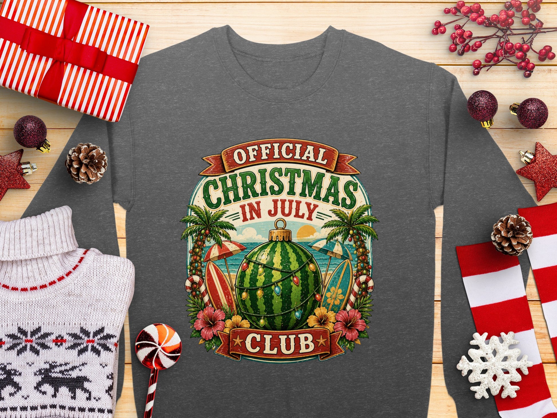 "Official Christmas in July" text on a watermelon surfboard with palm trees.