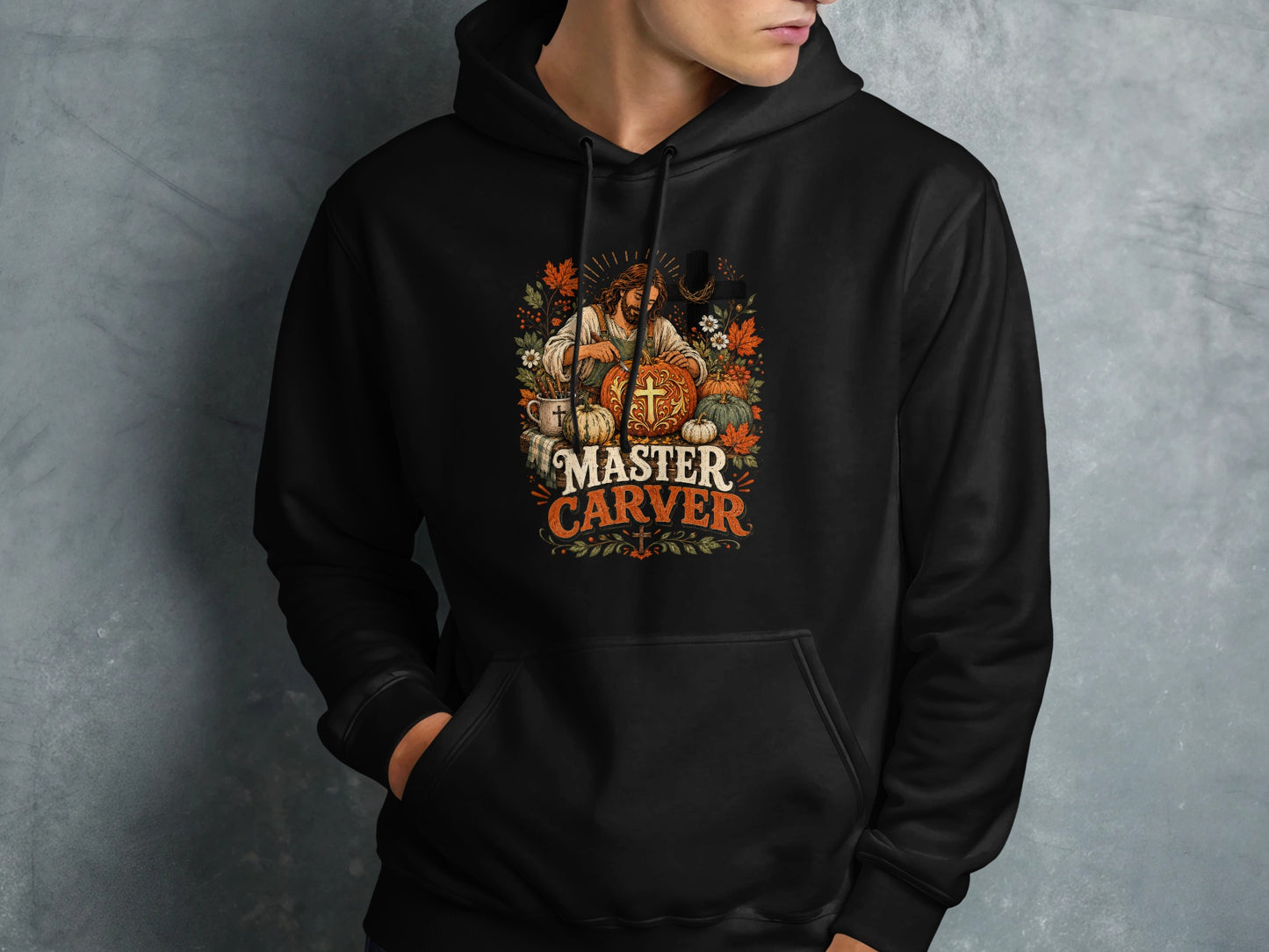 Black hoodie with "MASTER CARVER" text and a pumpkin-themed Jesus illustration.