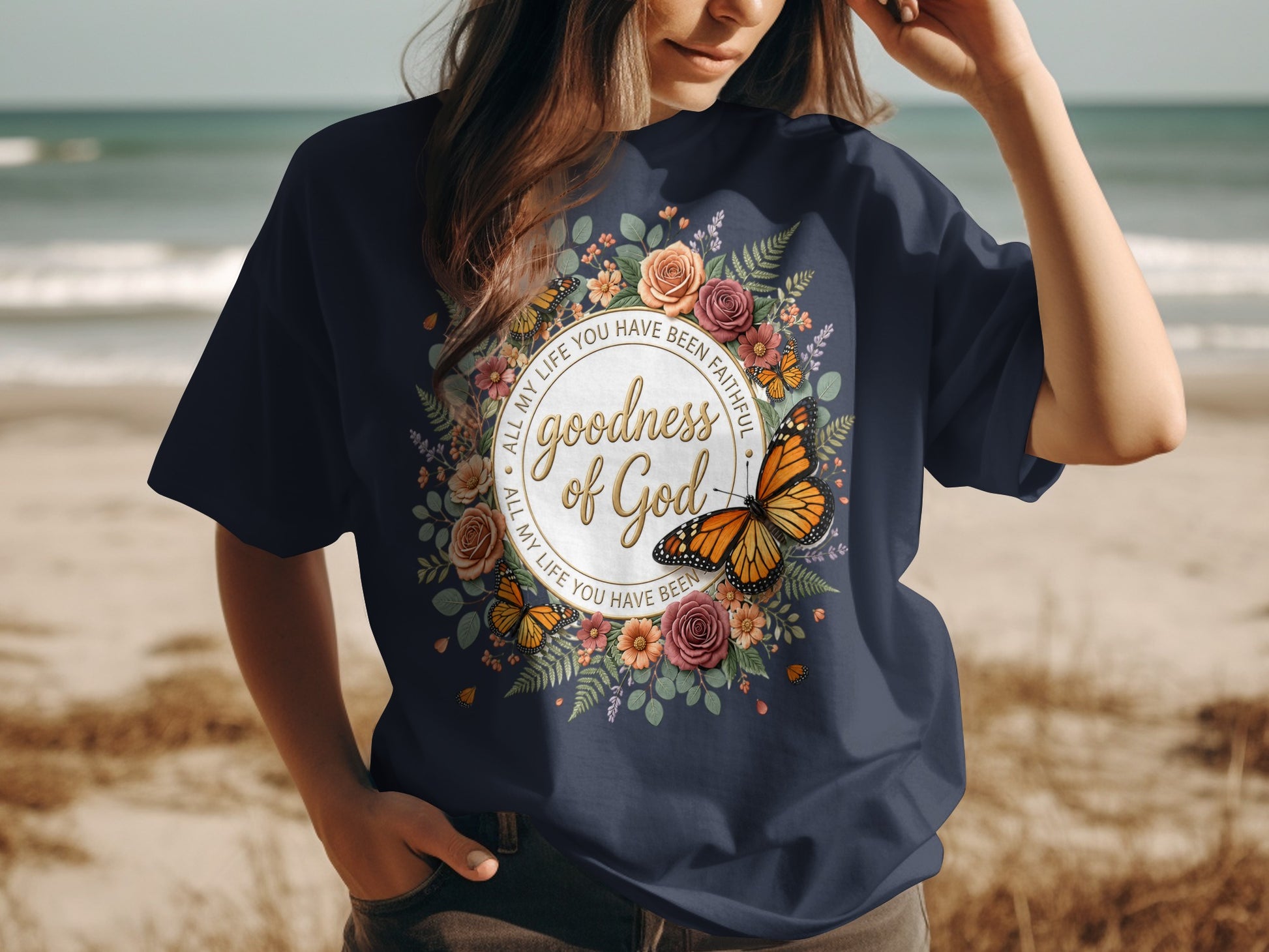 Navy t-shirt with a floral and butterfly design and text.
