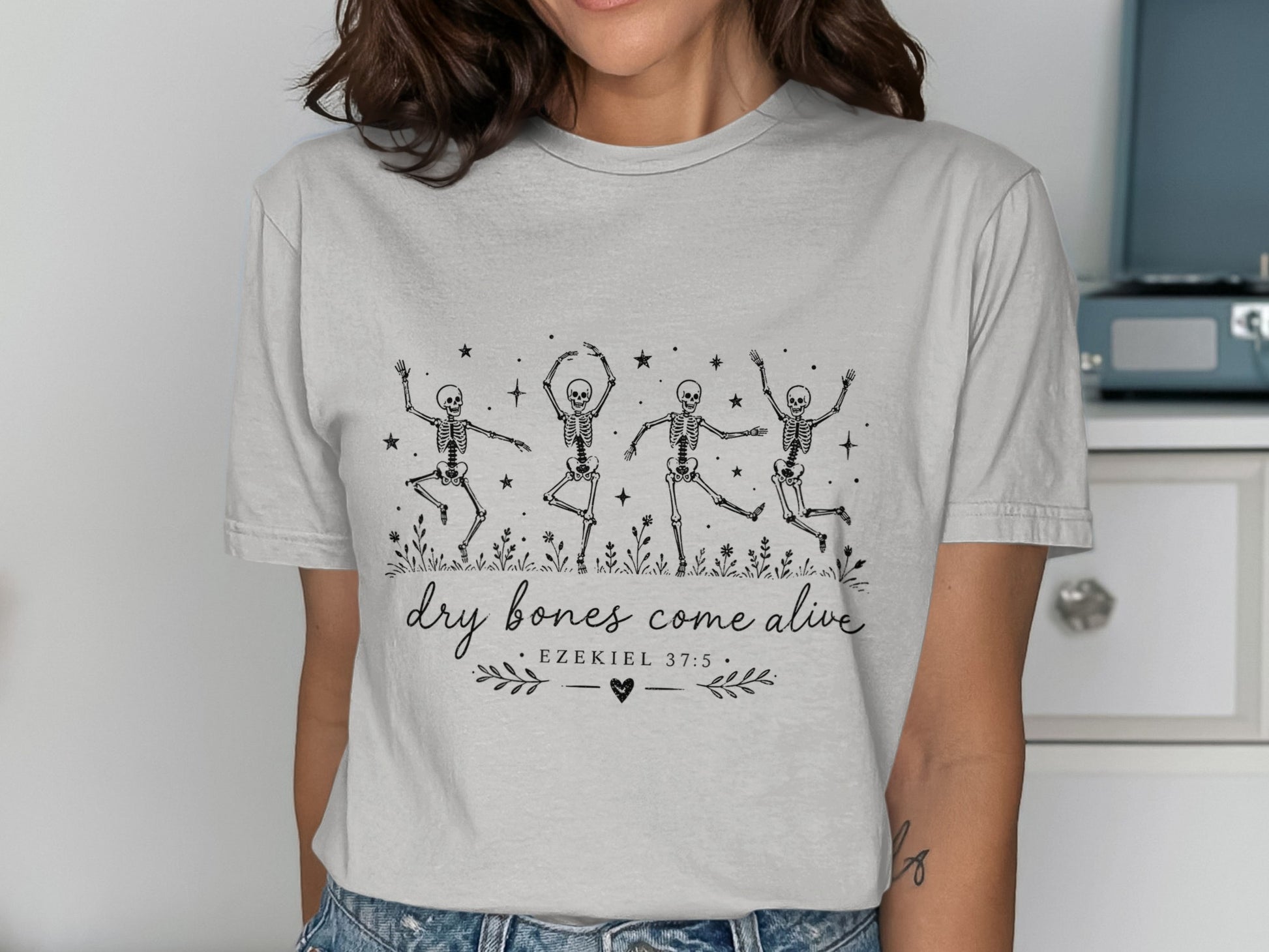 T-shirt with dancing skeletons and "dry bones come alive" text.