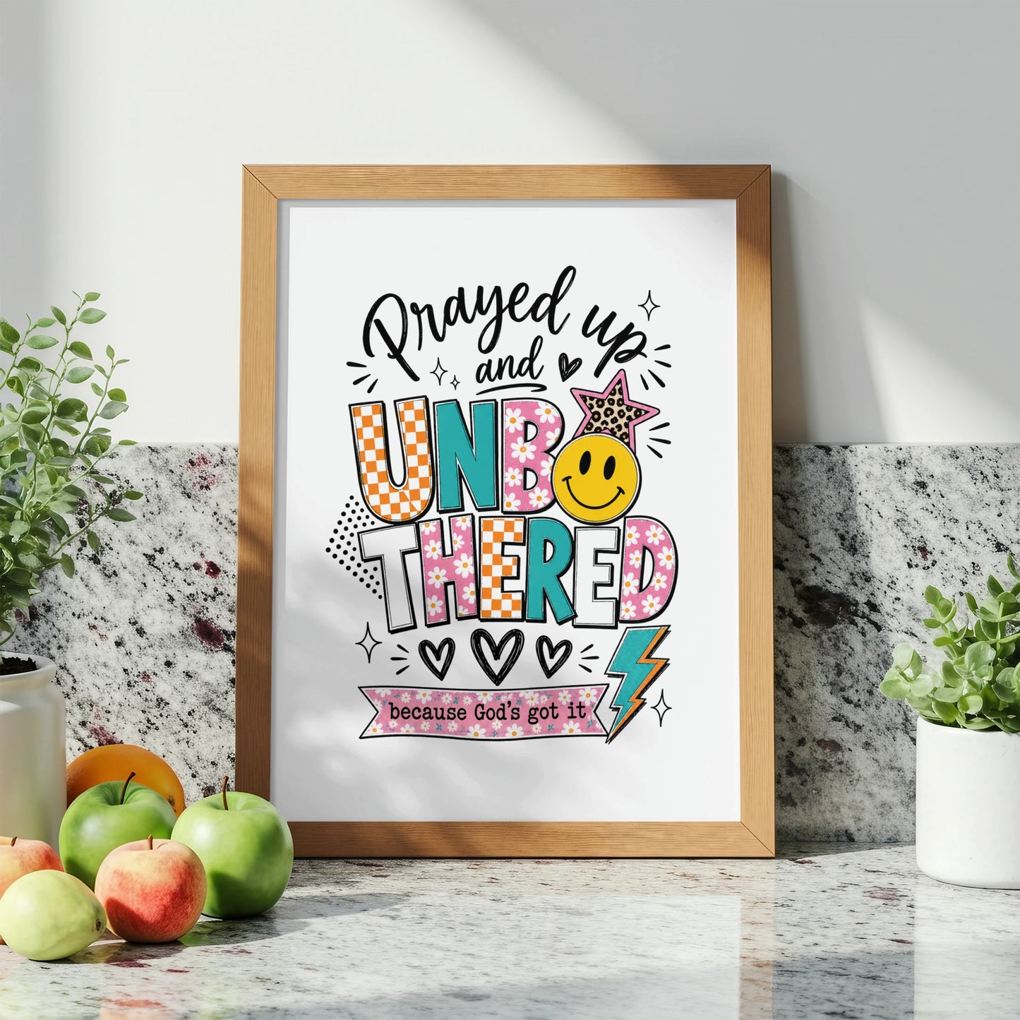 Framed artwork with text "Prayed up and UNBOTHERED because God's got it".