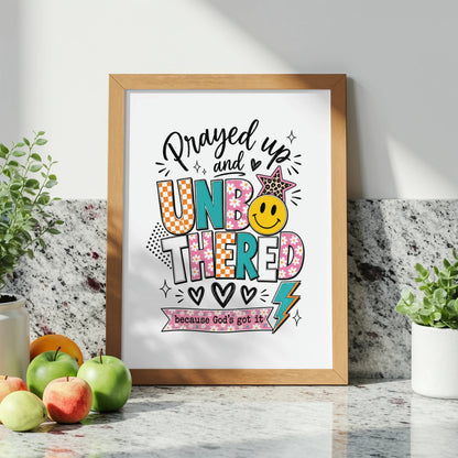 Framed artwork with text "Prayed up and UNBOTHERED because God's got it".