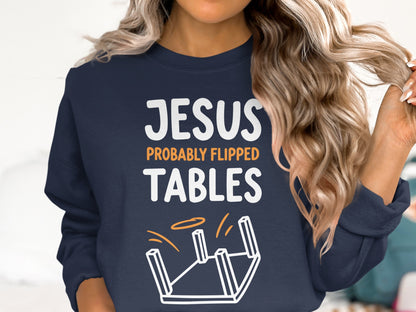 Navy sweatshirt with "Jesus Probably Flipped Tables" text and overturned table graphic.