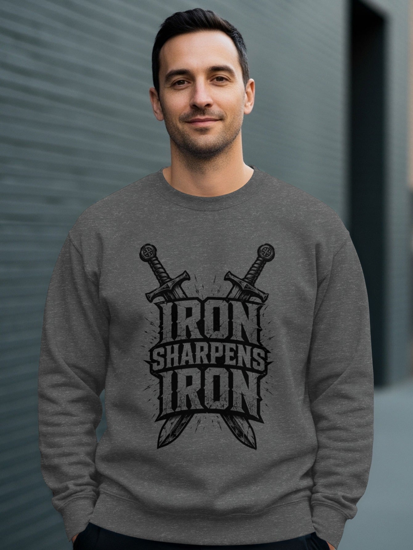 Man wearing a gray sweatshirt with crossed swords and "Iron Sharpens Iron" text.