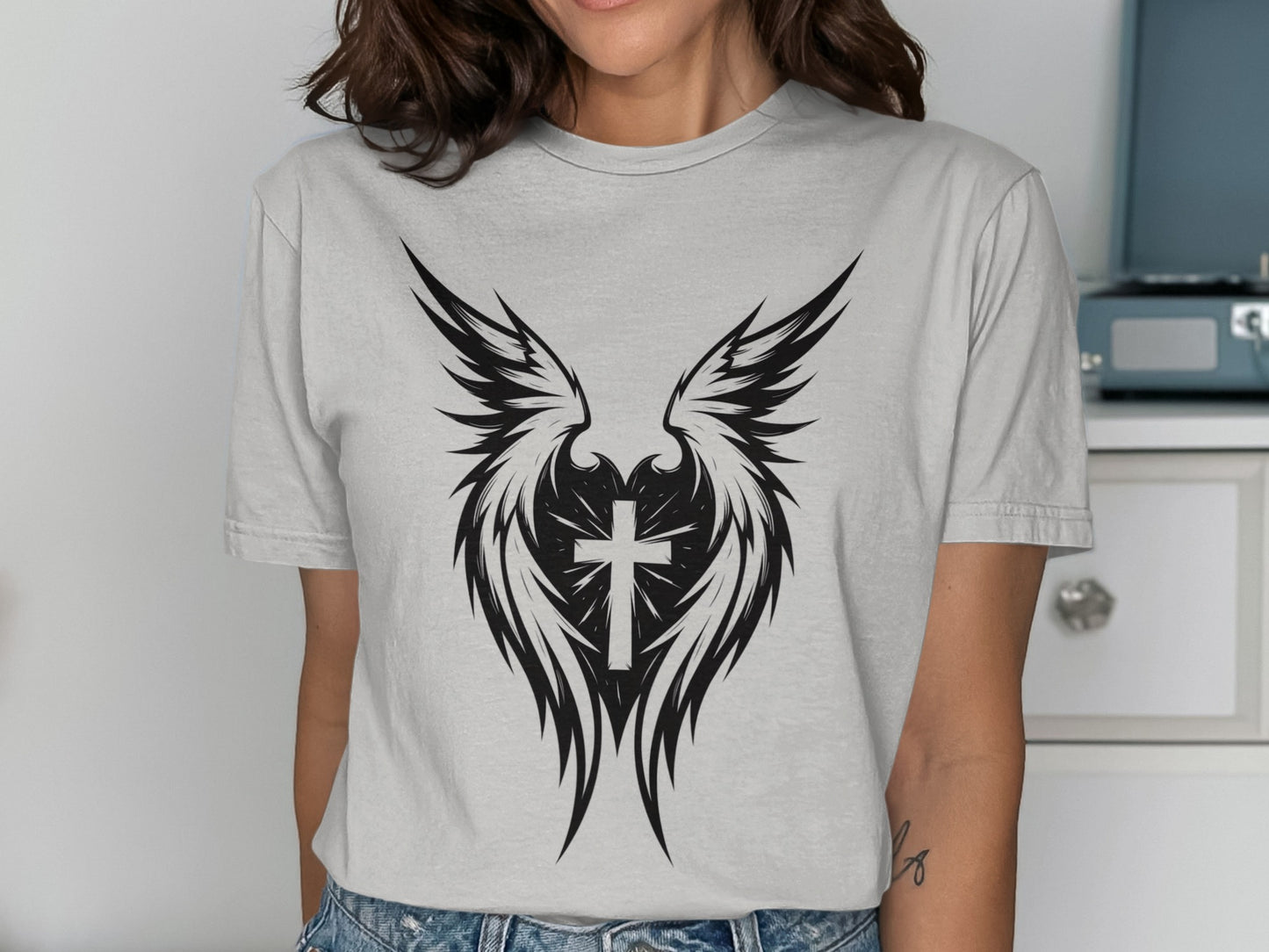 Gray graphic t-shirt with black winged cross design.