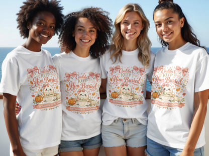 Four women in white t-shirts with a ghost design and text "Couldn't Keep Him Buried" and "He Lives."