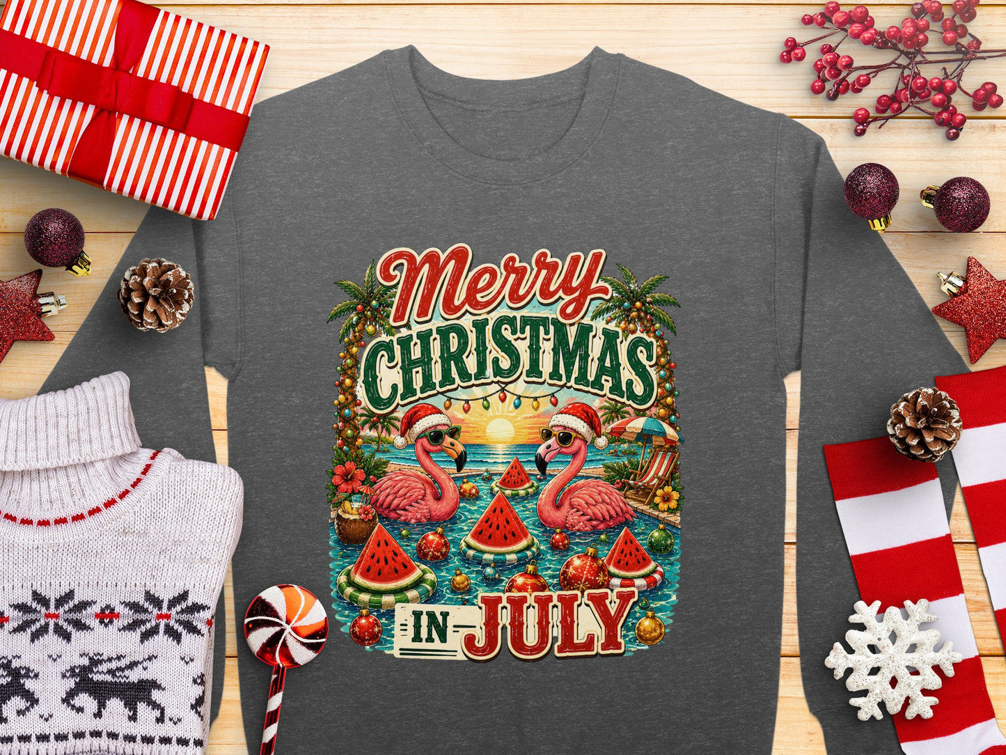 Merry Christmas in July graphic with two flamingos wearing Santa hats on a beach.