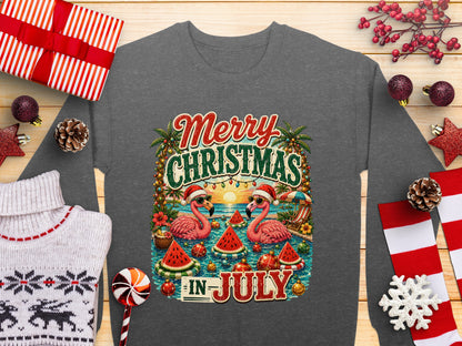 Merry Christmas in July graphic with two flamingos wearing Santa hats on a beach.