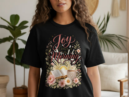 Black t-shirt with "Joy Comes in the Morning" text and floral sun design.