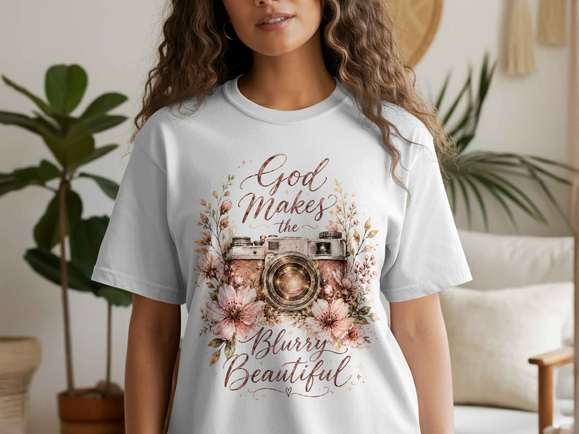 White t-shirt with floral camera graphic and text "God Makes the Blurry Beautiful".