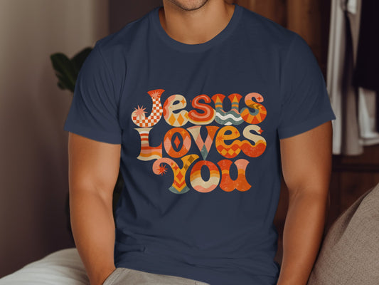 Navy t-shirt with "Jesus Loves You" in retro, colorful wavy text.