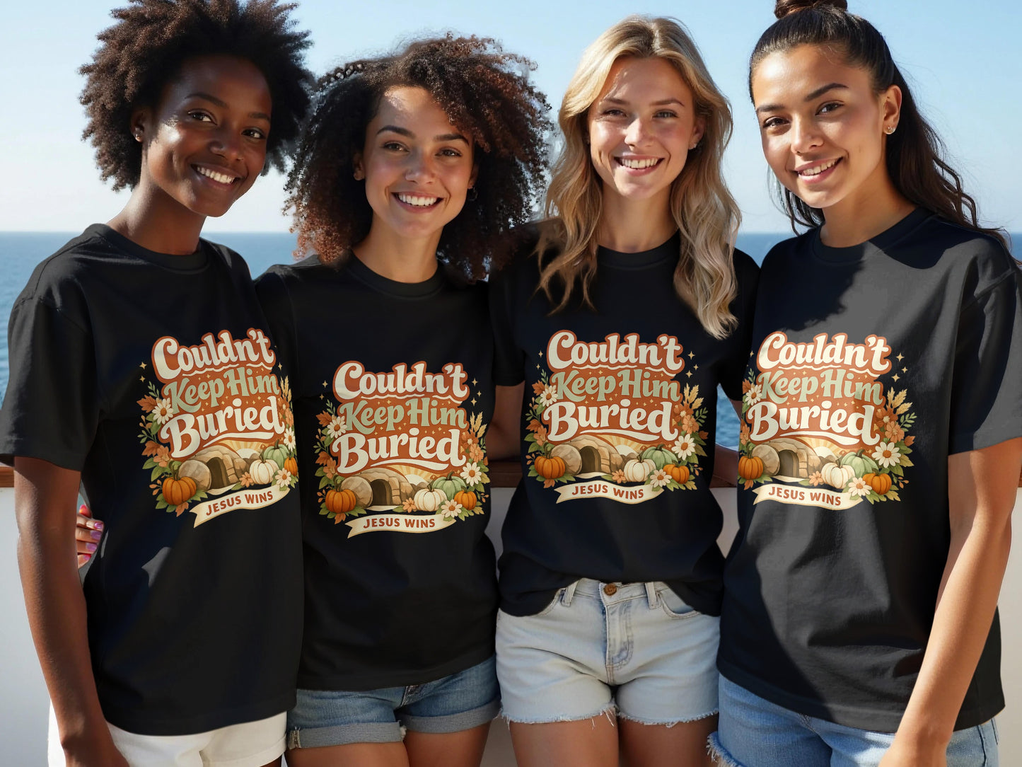 Four women smile wearing black t-shirts with "Couldn't Keep Him Buried" and "Jesus Wins" graphic.