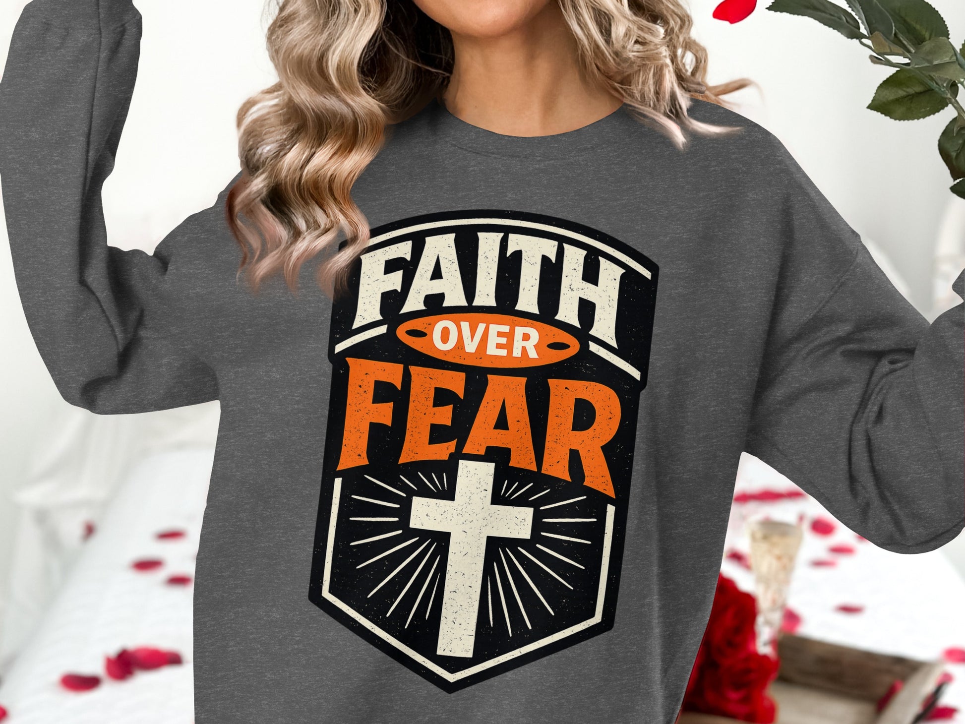 Dark gray sweatshirt with "FAITH OVER FEAR" and a cross design.
