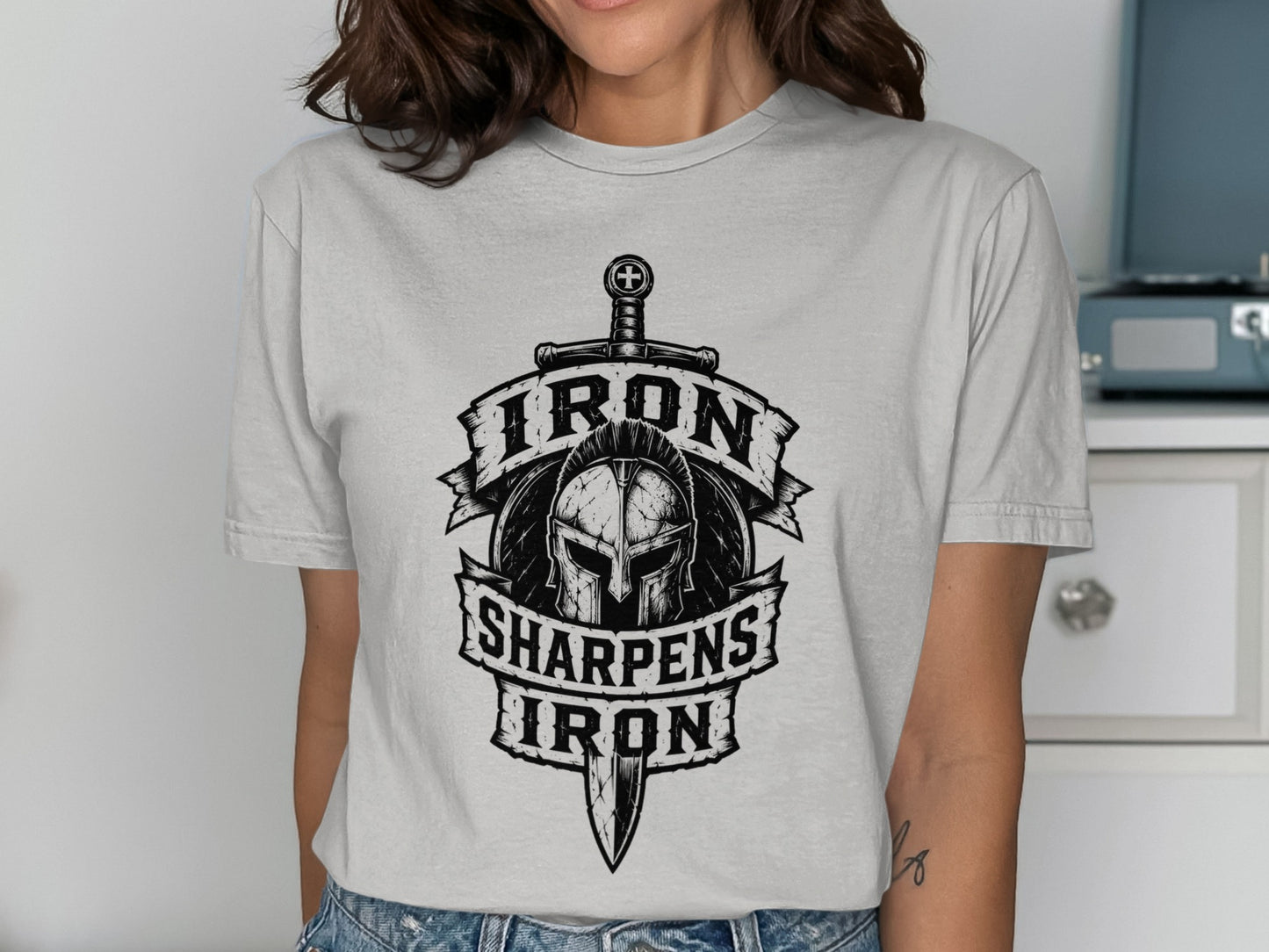 Shirt graphic with helmet, sword, and text "Iron Sharpens Iron".