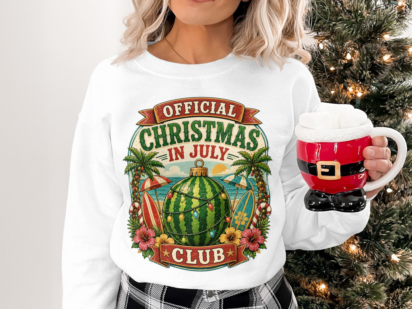 Christmas in July graphic on a white sweatshirt featuring watermelon and beach elements.
