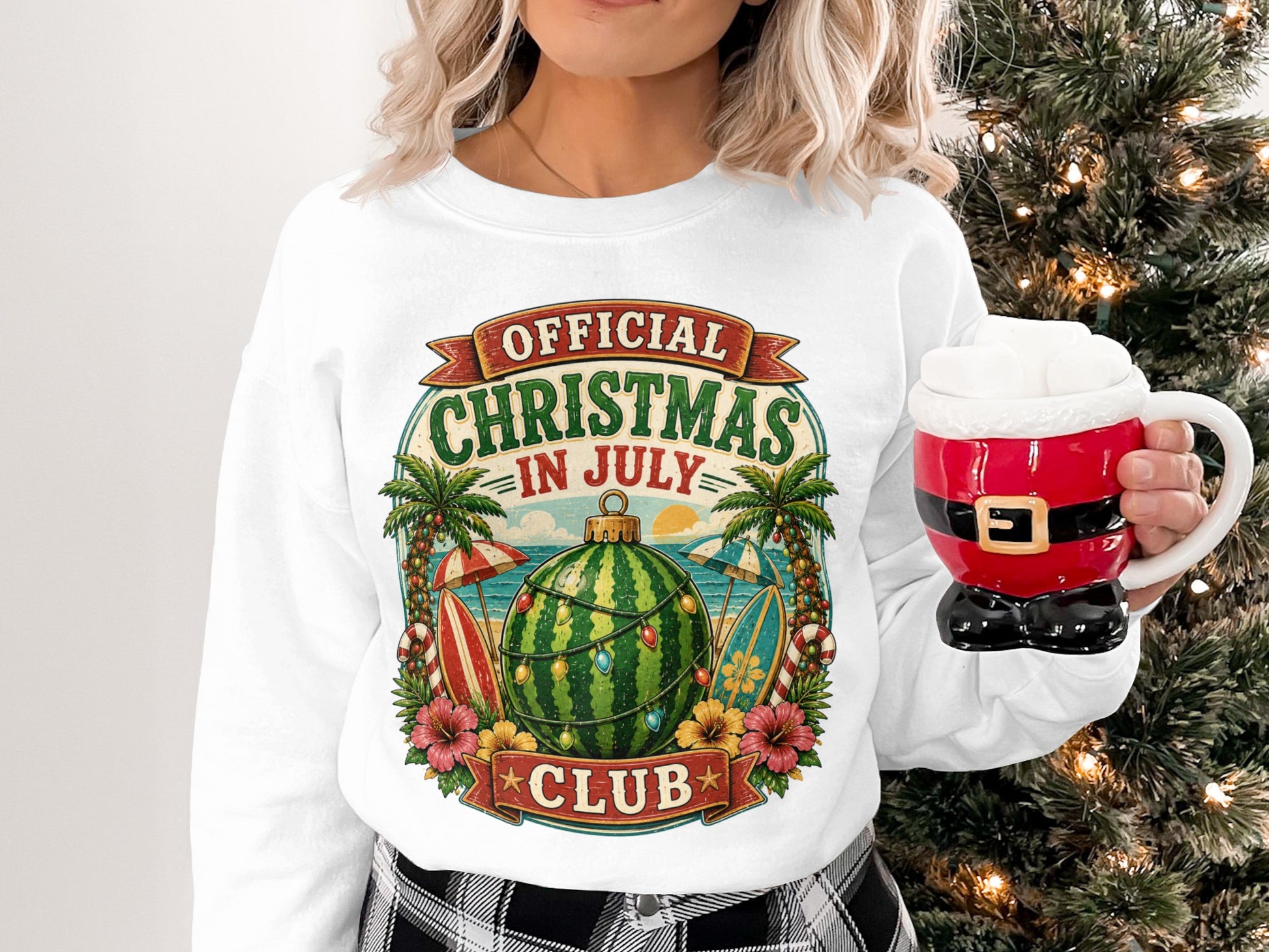 Christmas in July graphic on a white sweatshirt featuring watermelon and beach elements.