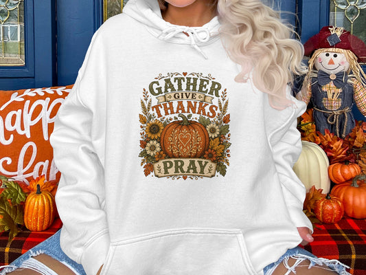 White hoodie with "Gather Give Thanks Pray" text and floral pumpkin graphic.