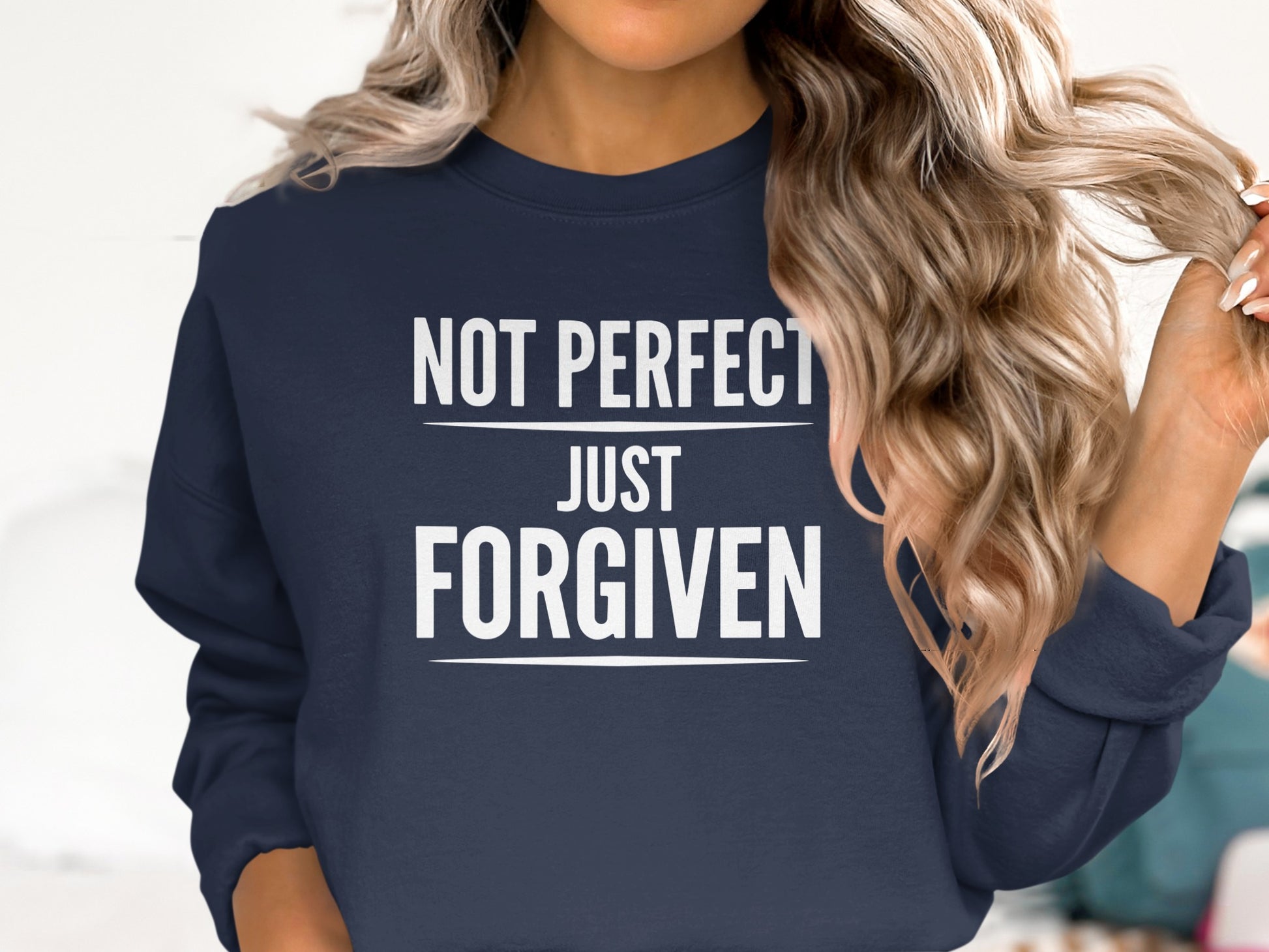 Navy sweatshirt with "Not perfect just forgiven" white text.