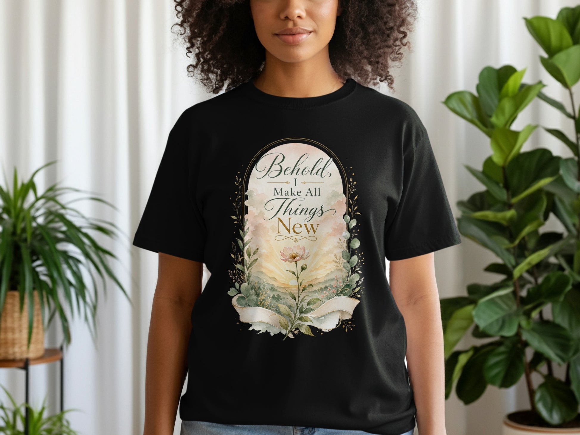 Black t-shirt with "Behold, I make all things new" text and floral design.