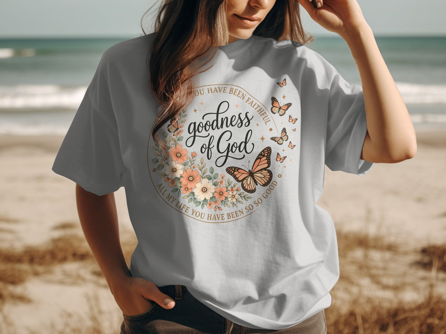 T-shirt with "Goodness of God" text and floral butterfly design.