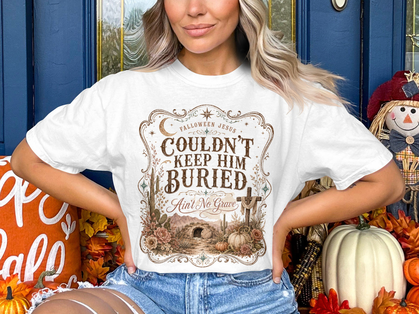 White t-shirt with "Couldn't Keep Him Buried Ain't No Grave" and tomb graphic.