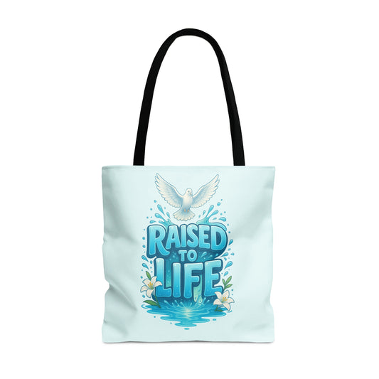 Light blue tote bag with "RAISED TO LIFE" text, dove, water, and lilies.