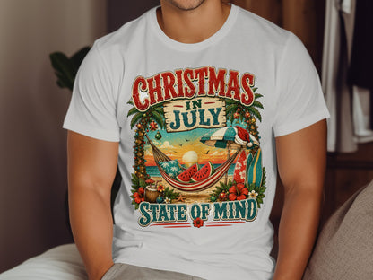 White t-shirt with "Christmas in July" text, tropical beach scene.