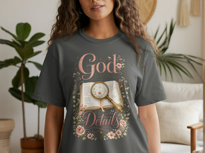 Dark gray t-shirt graphic with "God is in the Details" text and an open book.