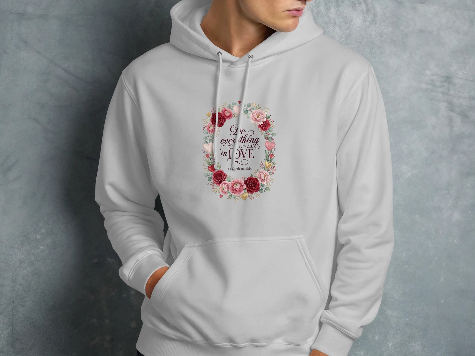 White hoodie with floral wreath and "Do everything in love" text.